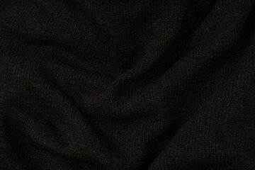Fototapeta premium Dark grey sweater texture as a background. Knitted pattern.