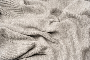 Grey wool sweater texture as a background.