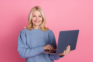 Naklejka premium Photo portrait of pretty retired female hold netbook wear trendy blue knitted outfit isolated on pink color background