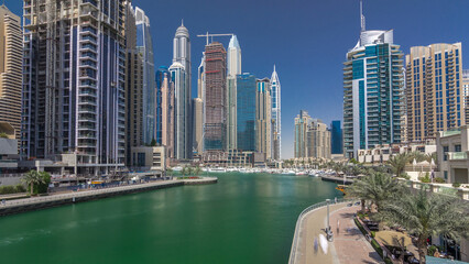 Obraz premium Panoramic view with modern skyscrapers and yachts of Dubai Marina timelapse hyperlapse, United Arab Emirates