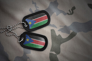army blank, dog tag with national flag of south sudan on the khaki texture background. military concept.