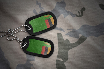 army blank, dog tag with national flag of zambia on the khaki texture background. military concept.