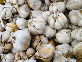 A group of garlic at market. Organic garlic for the consumer at the market. The detail of the garlic. Close up garlic and top view. 