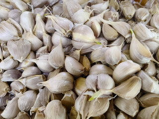 A group of garlic at market. Organic garlic for the consumer at the market. The detail of the garlic. Close up garlic and top view. 