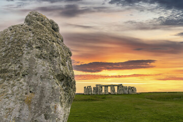 Sunset clouds and close up of heel stone that indicatis location of solstice with in background...