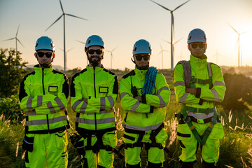 Teamwork four young male wind farm engineers work inspecting field systems.Wind turbine engineer inspection and wind turbine inspection progress at construction site.