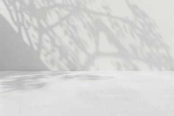 Fototapeta premium soft minimalistic image featuring a light colored surface with delicate shadows cast by nearby foliage creating a serene and tranquil atmosphere.