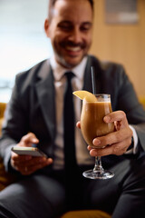 Close up of entrepreneur having protein drink in cafe.