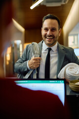 Happy businessman communicating with gym receptionist while checking in for sports training.