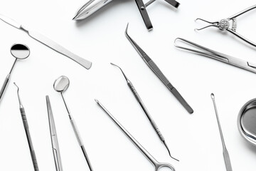Surgical professional stainless metal instruments on white background, top view. Medical equipment