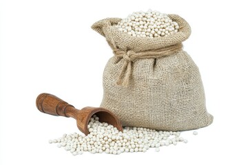 Sack of Job s tears with wooden scoop on white background