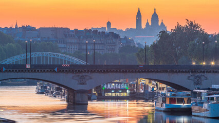 Fototapeta premium Bridge near Eiffel tower and the Seine river night to day transition timelapse before sunrise, Paris, France.