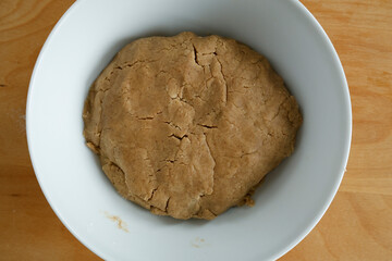 Making gingerbread. Kneaded dough in a white bow.