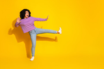 Full size photo of nice young woman fight empty space isolated on yellow color background