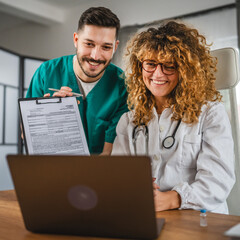 two colleagues man and woman doctors have video call in office