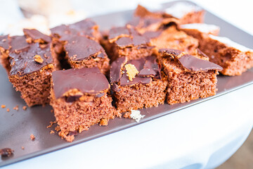 Delicious Chocolate Cake Squares on a Black Plate Decorated With a Chocolate Glaze