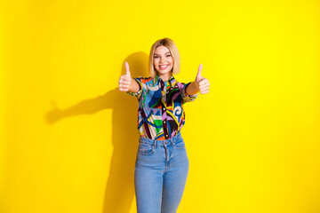 Photo portrait of attractive young woman show thumb up dressed stylish colorful clothes isolated on yellow color background
