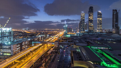 Fototapeta premium Aerial view of Financial center road night to day timelapse with under construction building