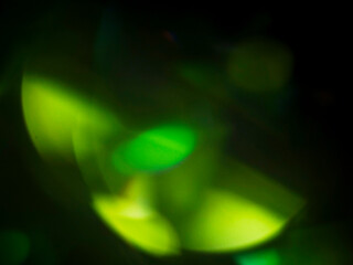 Abstract light leak effect on dark background for creating special effects. The colors are vibrant and the circles are overlapping, creating a sense of movement and energy. Abstract art.