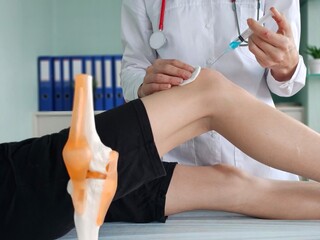 Person Receiving Knee Injection in Hospital concept