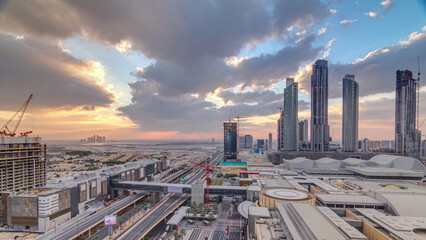 Obraz premium Sunrise aerial view of Financial center road morning timelapse with under construction building