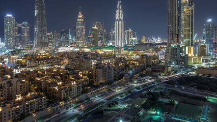 Obraz premium Dubai Downtown skyline night timelapse with Burj Khalifa and other towers panoramic view from the top in Dubai