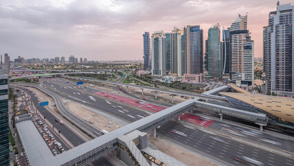 Fototapeta premium Aerial top view to Sheikh Zayed road near Dubai Marina and JLT day to night timelapse, Dubai.