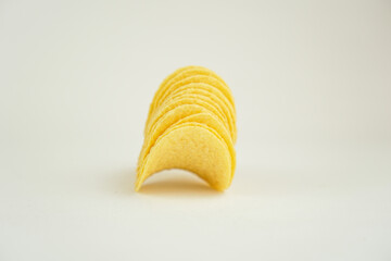 Crispy potato chips isolated on white background
