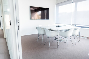 Modern Corporate Conference Room with White Chairs and a Bright Interior