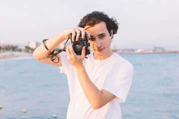 Concentrated man photographing on shore