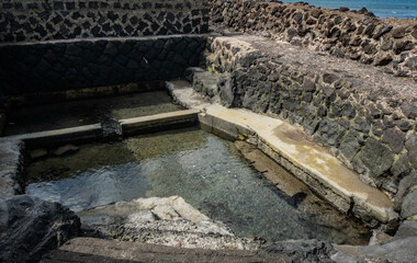 Fototapeta premium Traditional bathing pool along the Jeju Olle Trail in rural Jeju Island, South Korea