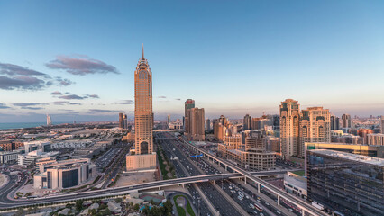 Skyline internet city with crossing Sheikh Zayed Road aerial day to night timelapse