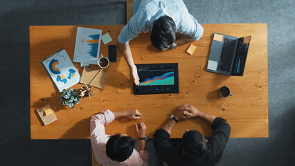Top aerial view of business man present financial graph to group of smart investors. Professional...