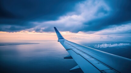 Obraz premium A serene view from an airplane wing, showcasing a dramatic sky and tranquil ocean beneath, evoking a sense of adventure and exploration.