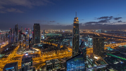 Fototapeta premium Dubai International Financial Centre district with modern skyscrapers night to day timelapse