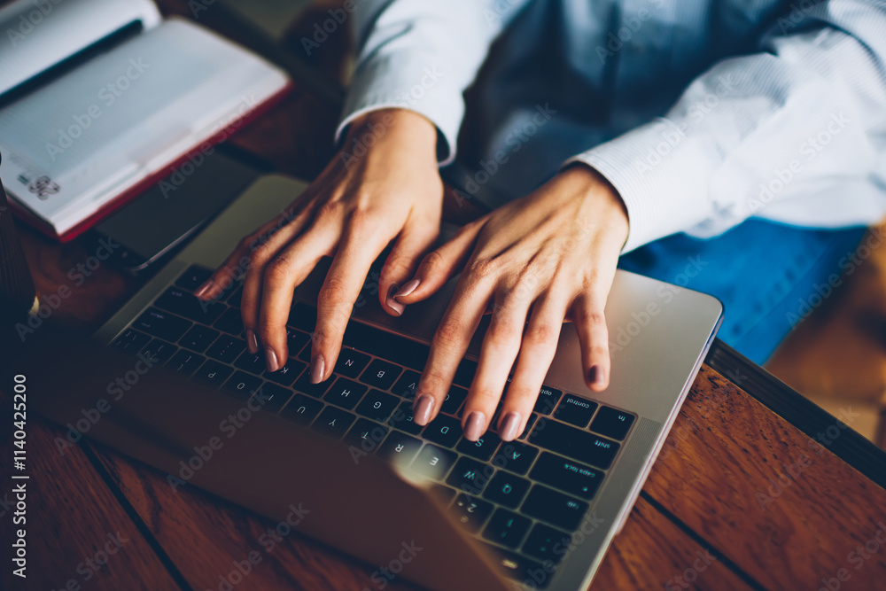 Poster cropped image of female hands typing text on keyboard of modern laptop computer device connected to 