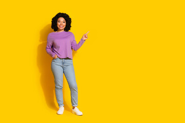 Full size photo of nice young woman direct finger empty space isolated on yellow color background