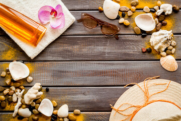 Beach accessories flat lay - sunscreen and sunglasses with straw hat, top view