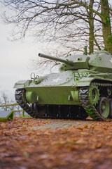 Fototapeta premium Historic Military Tank in a Scenic Forest Park Setting Highlighting War History and Vehicle Engineering