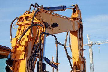 Hydraulic Excavator Arm Detail with Hoses and Metal Components