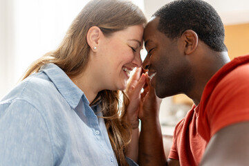 Portrait of happy middle aged couple relaxing together in their living room, holding hands