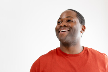 Smiling African American man in t shirt looking at copy space