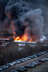 Orange toxic smoke from flames or fires of warehouses and industrial building. Burning house or...