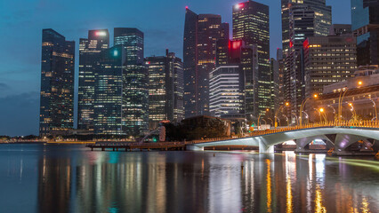 Esplanade bridge and downtown core skyscrapers in the background Singapore night to day timelapse