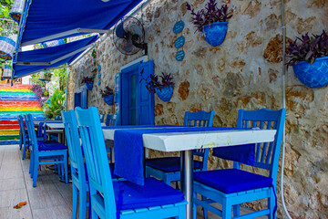 Cafe with blue furniture near colorful stairs in city Kalkan, Turkey