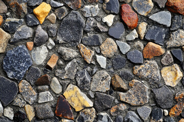 Colorful variety of stones creating a textured surface in a natural setting