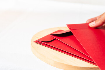 Festive Red Envelopes on Wooden Platter