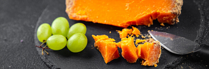 Aged cheese Mimolette or cheddar fresh tasty food dish delicious gourmet food background on the...