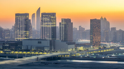 Fototapeta premium Buildings on Al Reem island in Abu Dhabi day to night timelapse from above.