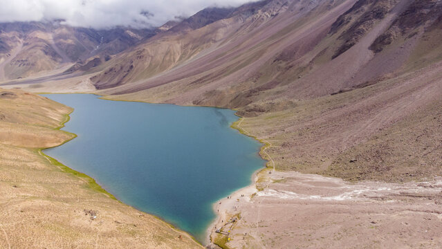 Aerial view of chandratal lake surrounded by snow-capped Himalayan mountains at chandratal in lahaul and spiti valley himachal pradesh, India.